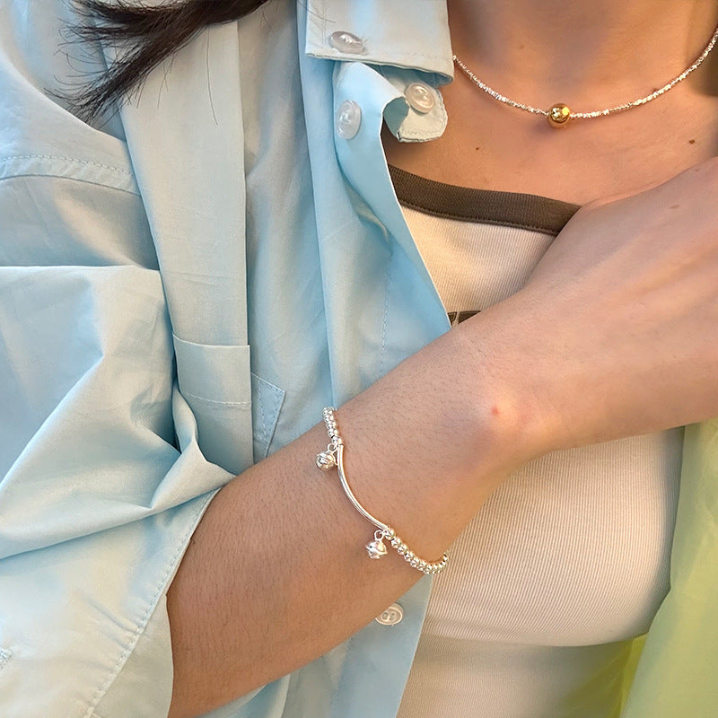 Silver bell curved tube bead bracelet made of 925 sterling silver, elegantly designed for young, fashionable women.