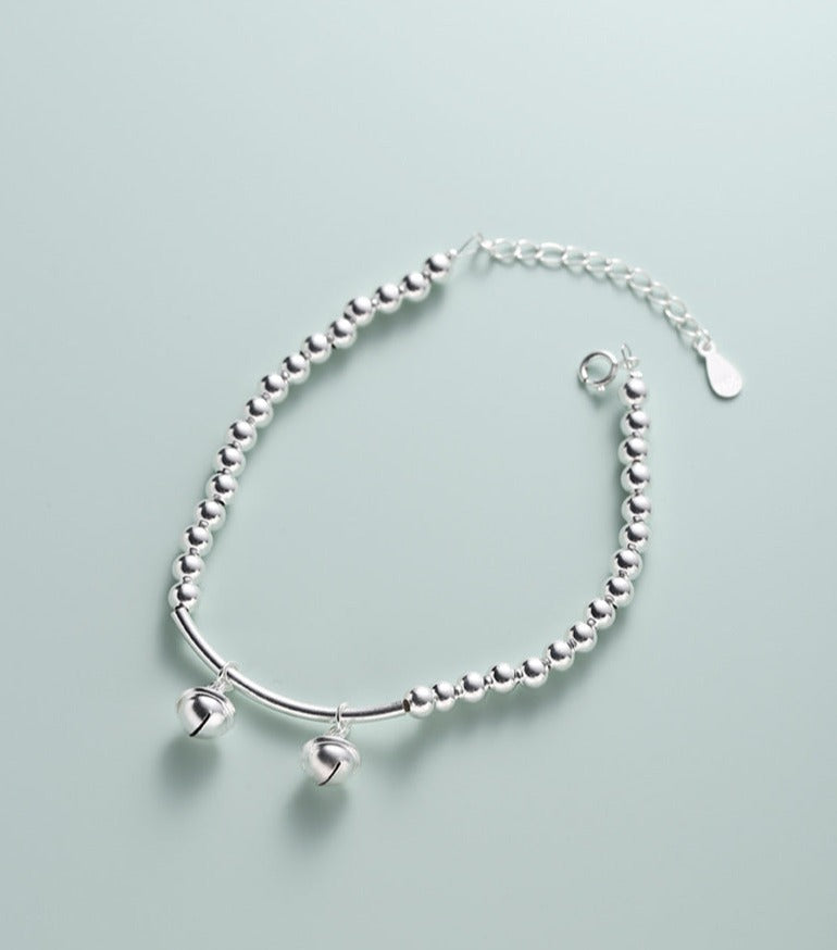 Silver bell curved tube bead bracelet made of 925 sterling silver, elegantly designed for young, fashionable women.