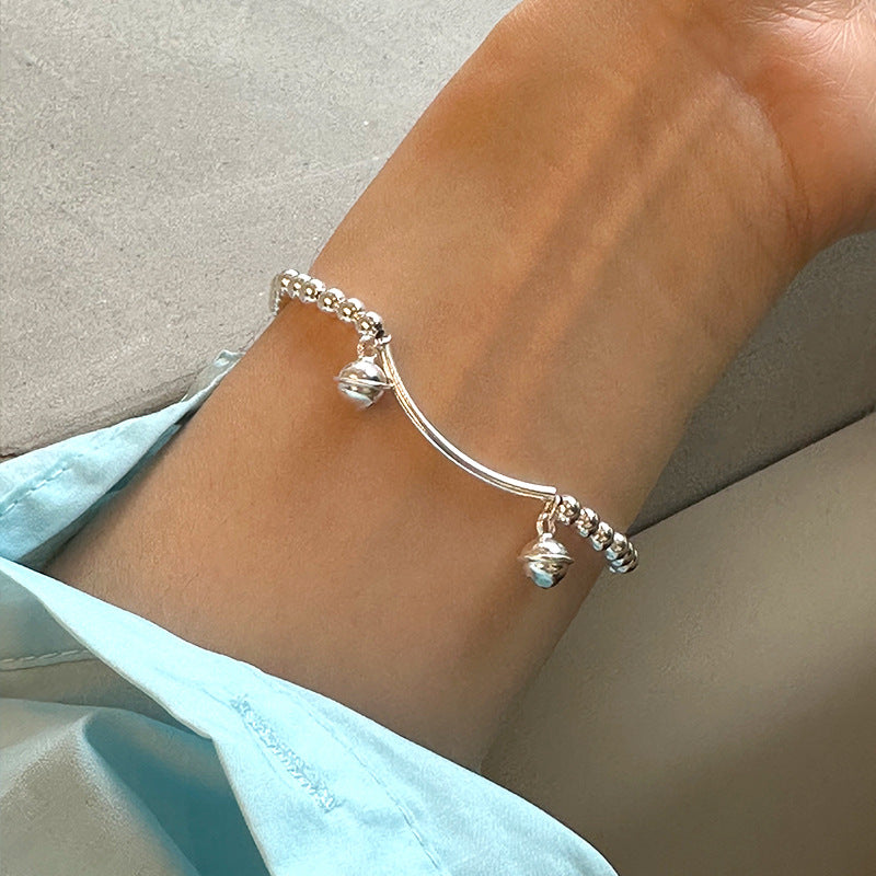 Silver bell curved tube bead bracelet made of 925 sterling silver, elegantly designed for young, fashionable women.