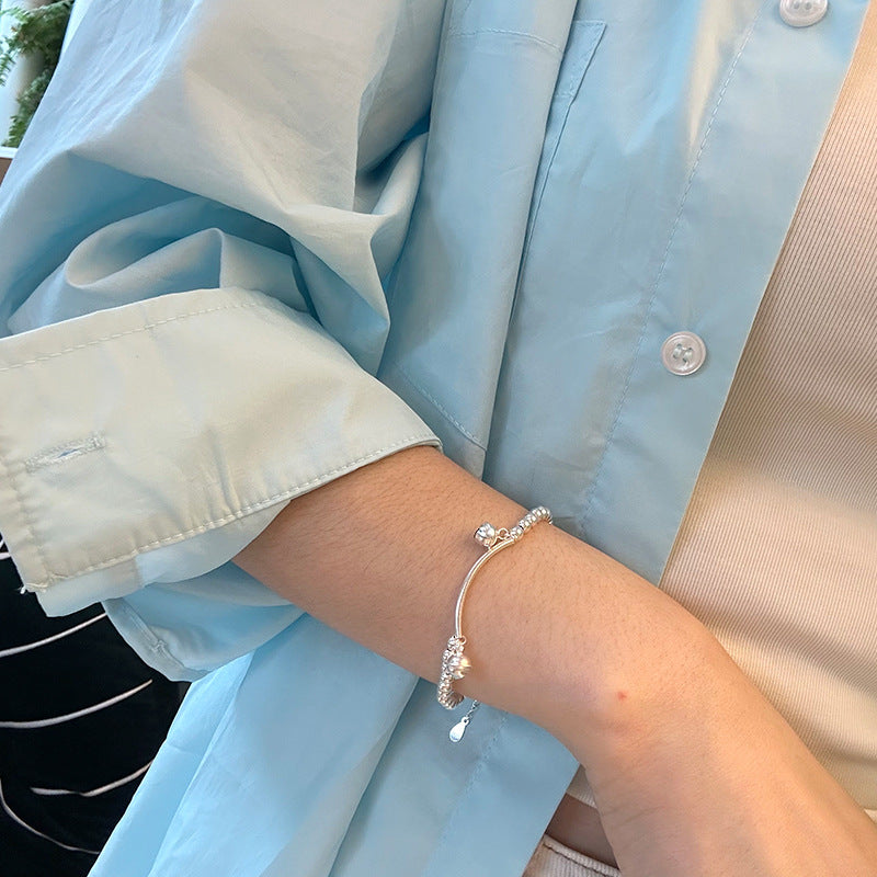 Silver bell curved tube bead bracelet made of 925 sterling silver, elegantly designed for young, fashionable women.