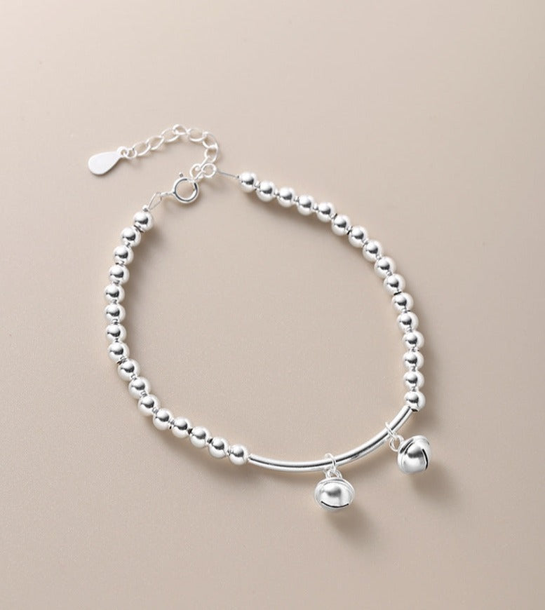 Silver bell curved tube bead bracelet made of 925 sterling silver, elegantly designed for young, fashionable women.