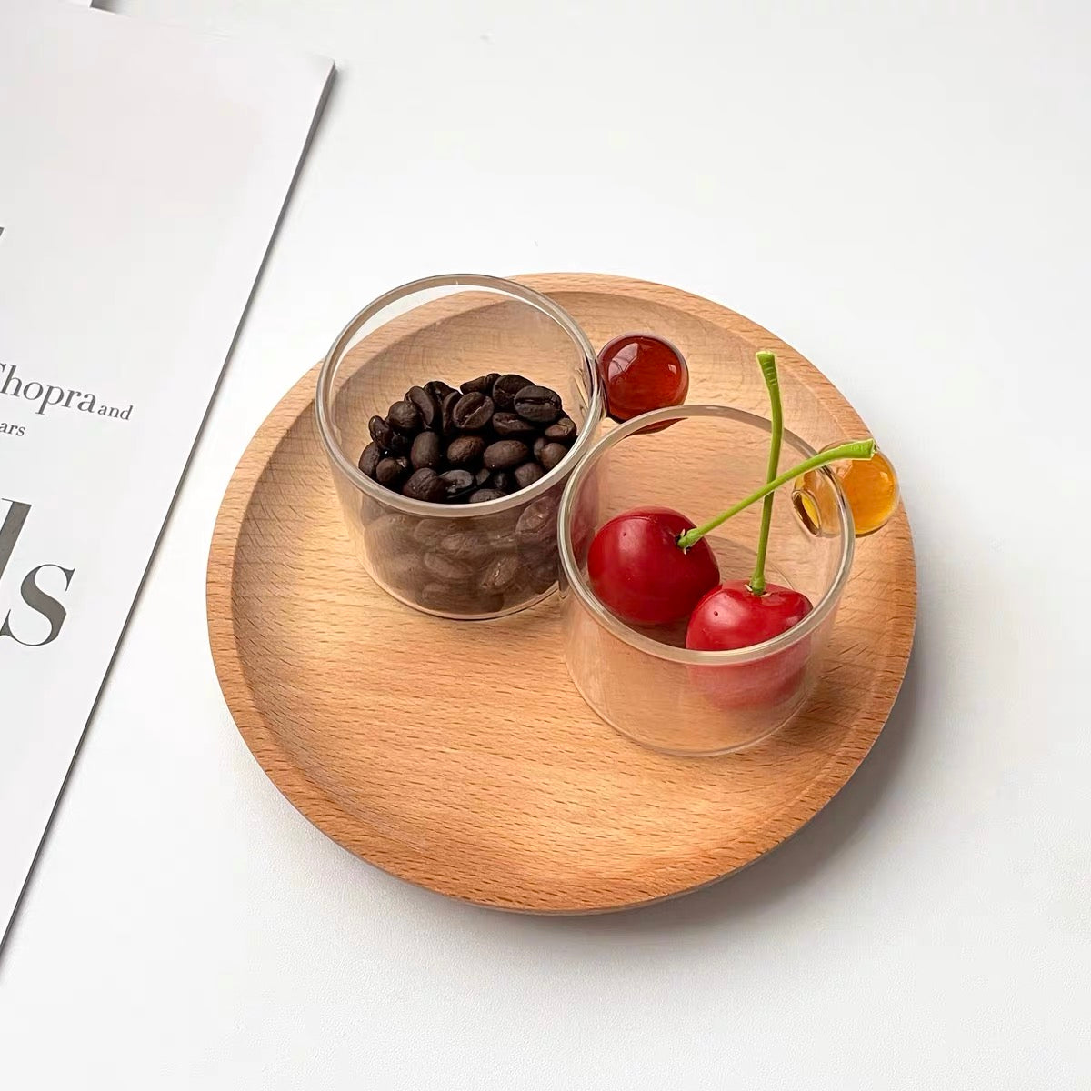 Transparent Glass Cup with a distinctive round ball handle, crafted from high borosilicate heat-resistant glass, showcasing a sleek design with a 5cm height and 5.5cm top diameter, perfect for hot beverages.