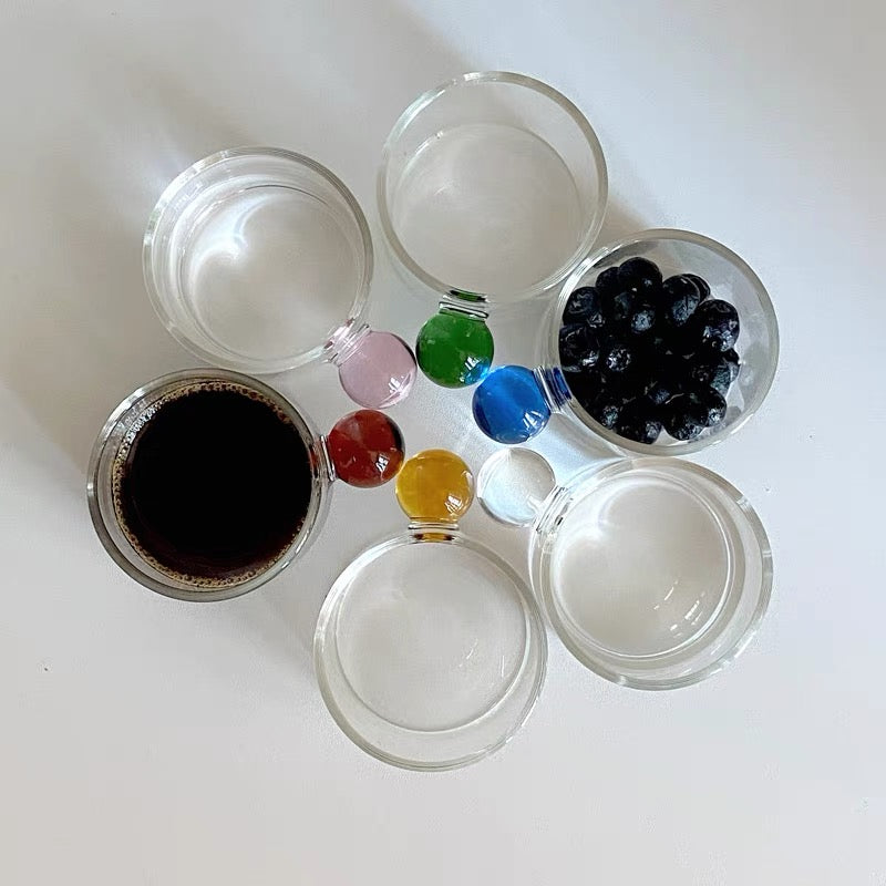 Transparent Glass Cup with a distinctive round ball handle, crafted from high borosilicate heat-resistant glass, showcasing a sleek design with a 5cm height and 5.5cm top diameter, perfect for hot beverages.