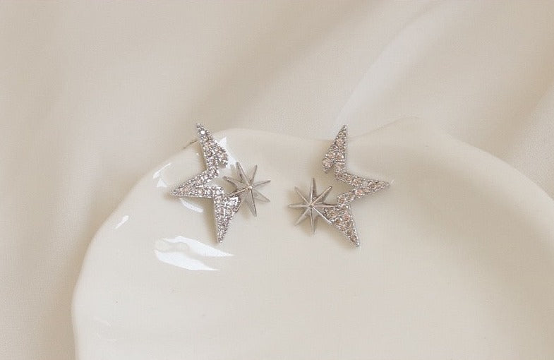 Gold-Plated Starry Zirconia Stud Earrings with star-shaped settings and 925 silver ear pins, weighing 1.6g each, measuring 1.8cm by 2.1cm.