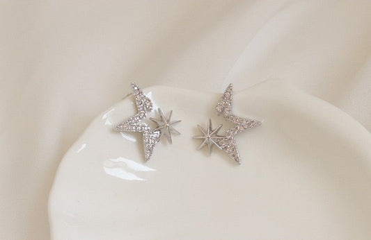 Gold-Plated Starry Zirconia Stud Earrings with star-shaped settings and 925 silver ear pins, weighing 1.6g each, measuring 1.8cm by 2.1cm.