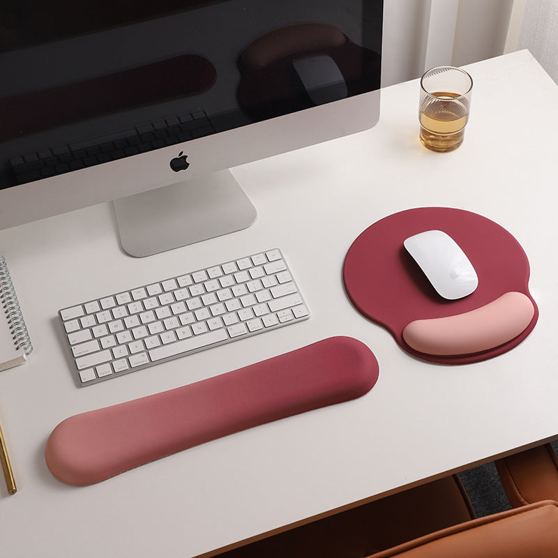 An ergonomic memory foam mouse pad with wrist support and a non-slip base, measuring 25x22 cm.