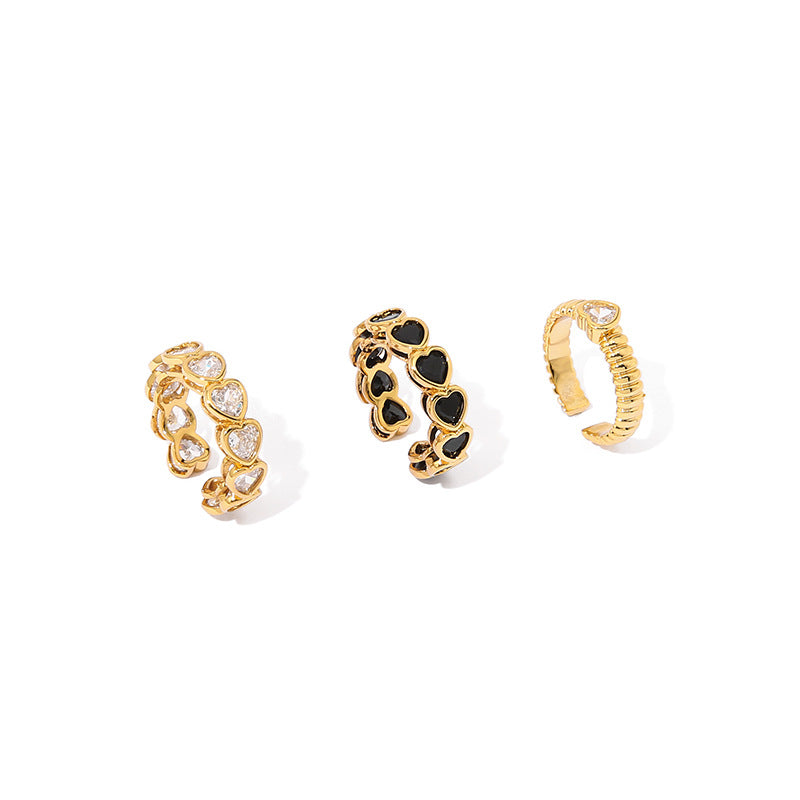 18k gold-plated openwork brass ring showcasing a heart-shaped zircon stone, with contrasting gold and black tones and an open-mouth design.