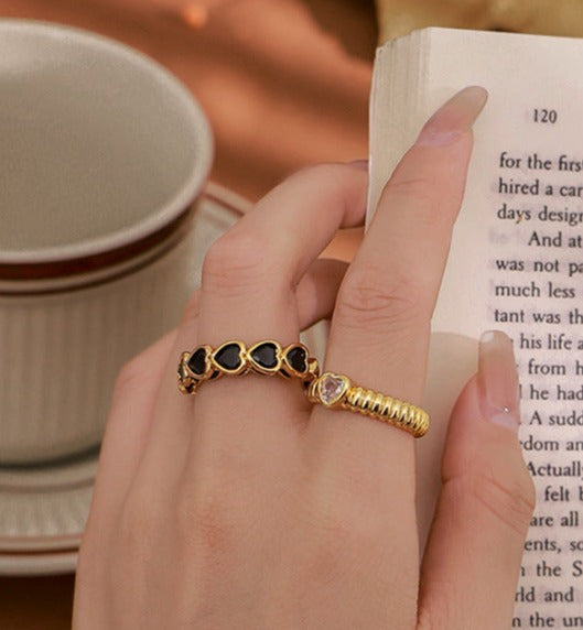 18k gold-plated openwork brass ring showcasing a heart-shaped zircon stone, with contrasting gold and black tones and an open-mouth design.