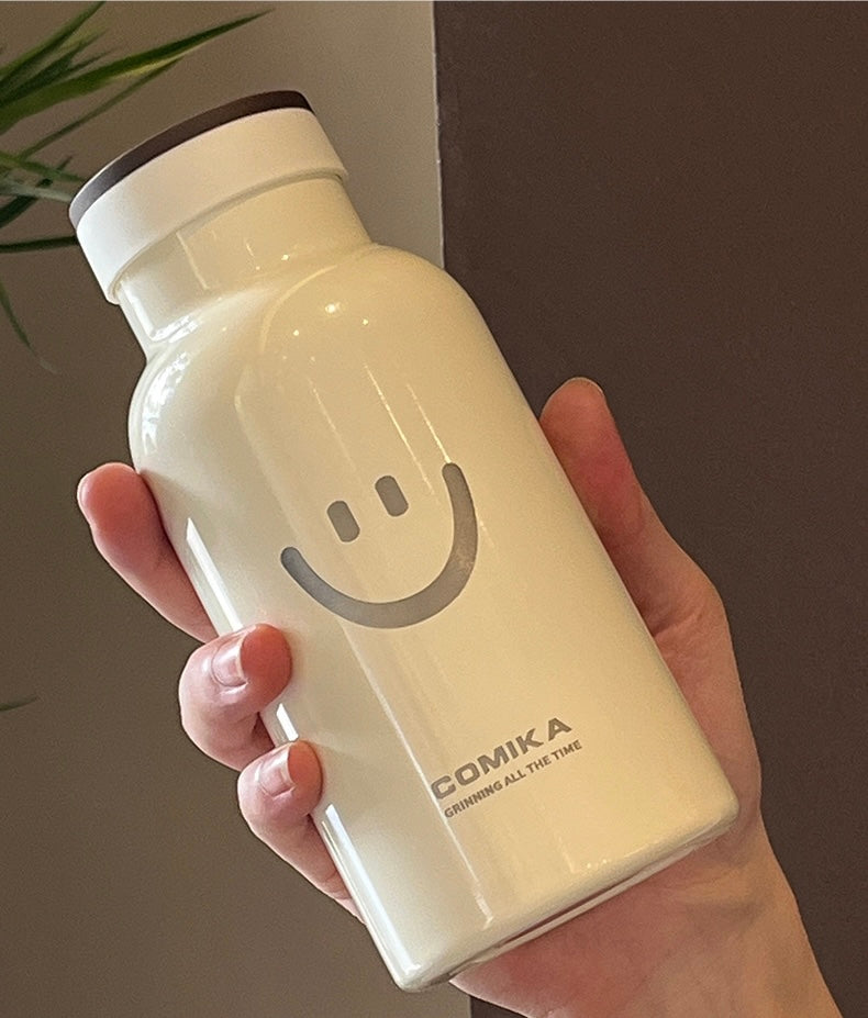 Yellow Smiley Face Thermal Bottle with a stainless steel inner lining, designed to keep beverages hot or cold. Iconic smiley face emblem prominently displayed on the front.