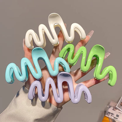 Candy-colored Wavy Hair Claw Clip made of premium acrylic, showcasing a playful wavy design in vibrant hues, approximately 10.5cm in length.